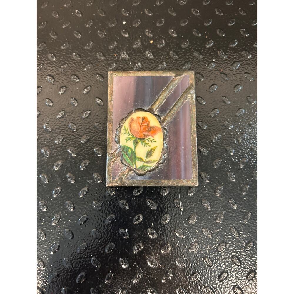 vintage hand mirror with pink rose and stained glass background